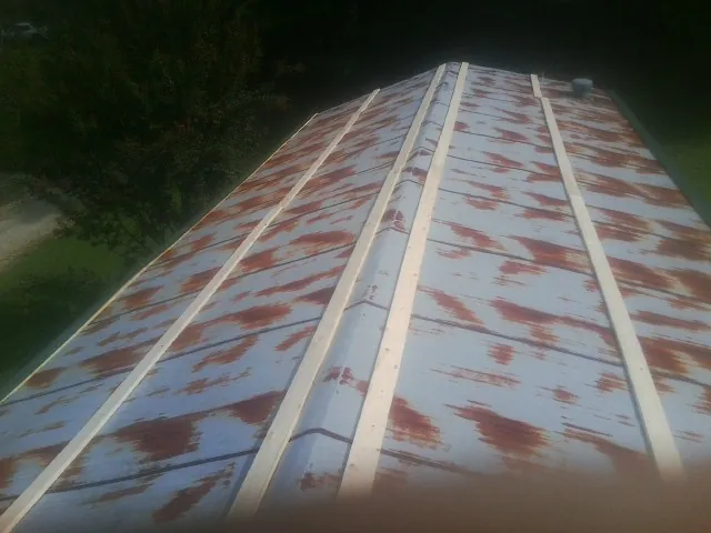Rusted metal roof panels with new wood purlins before replacement — Storm Damage Roof Repair in Yankeetown by Roofing Brothers