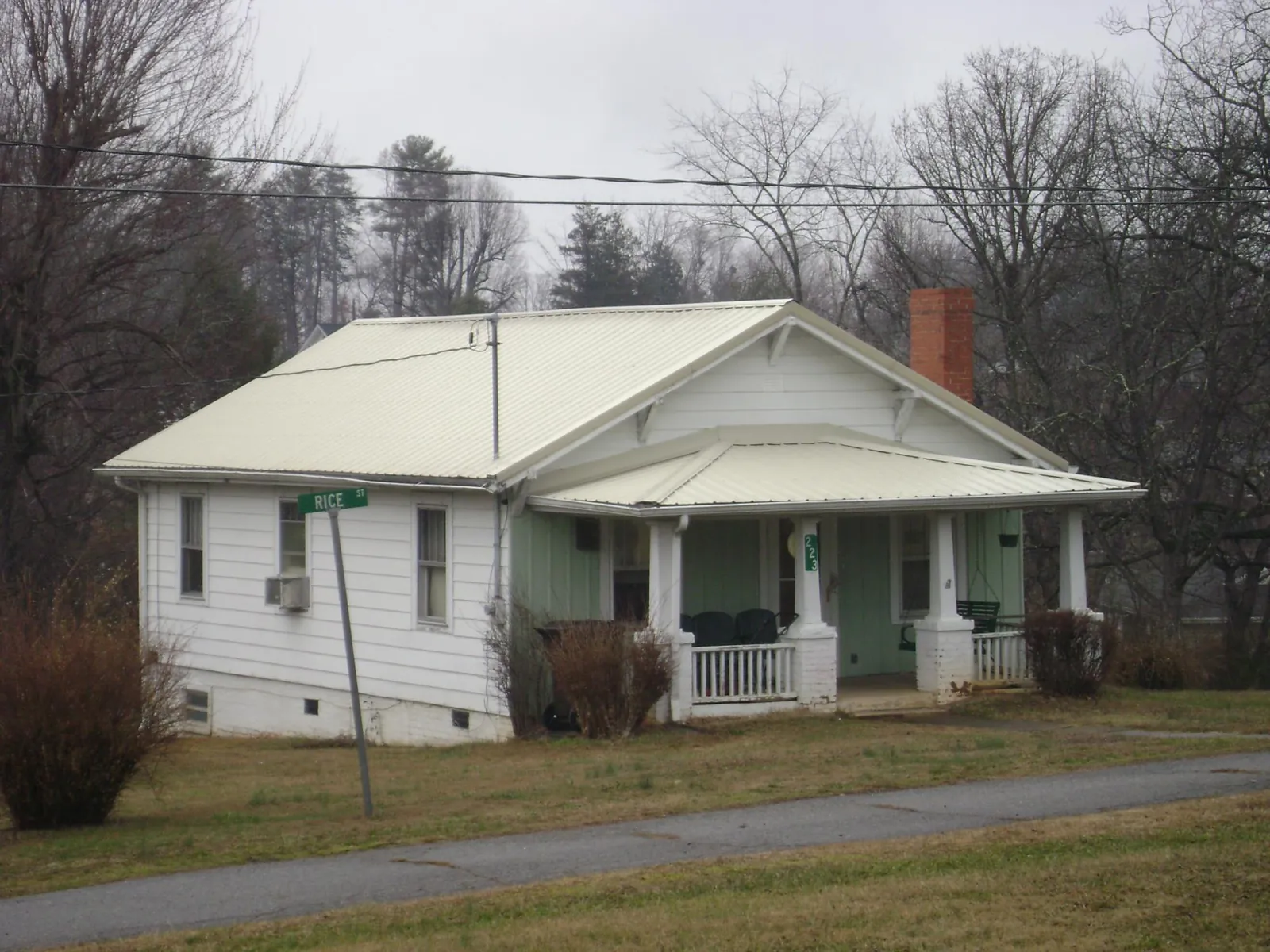 White metal roof on a craftsman bungalow at a street corner in Yankeetown